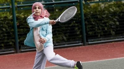 girl playing tennis