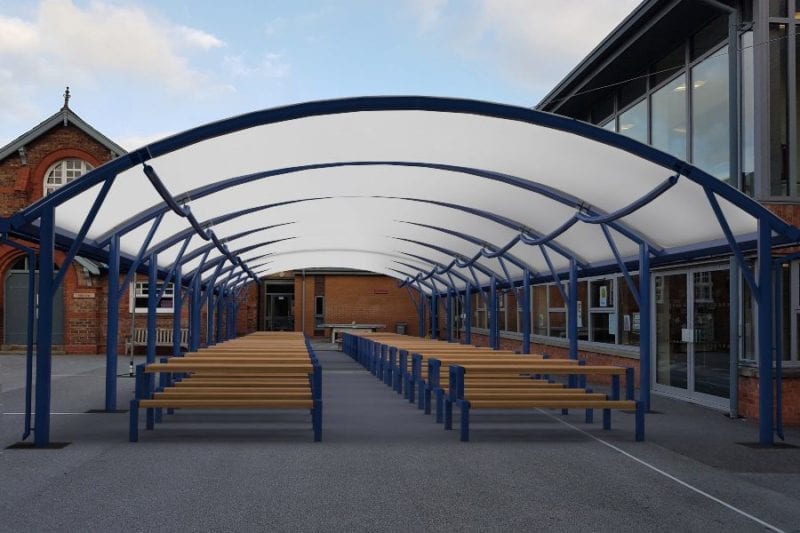 Blue school shelter with fabric roof