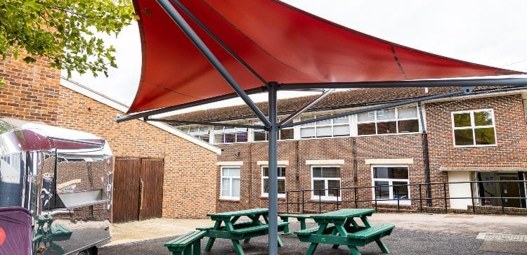 Red fabric shelter we installed for Hillview School for Girls