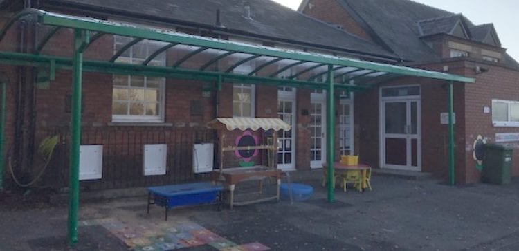Curved roof playground shelter we made for Holmer Academy