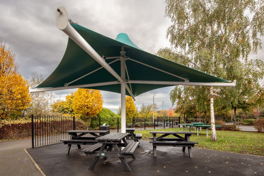 Shade Sail with Henry Benches beneath it.