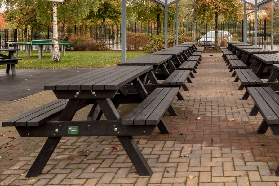 Henry Benches Lined up under and outdoor dining area canopy.